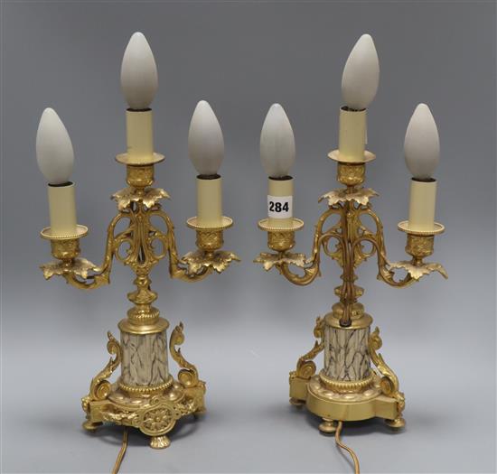 A pair of ormolu three light candelabra